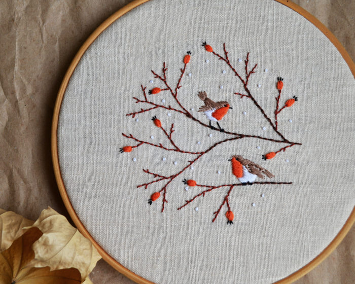 Hand embroidery with birds and berries