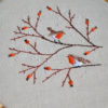 Hand embroidery with birds and berries