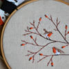 Hand embroidery with birds and berries