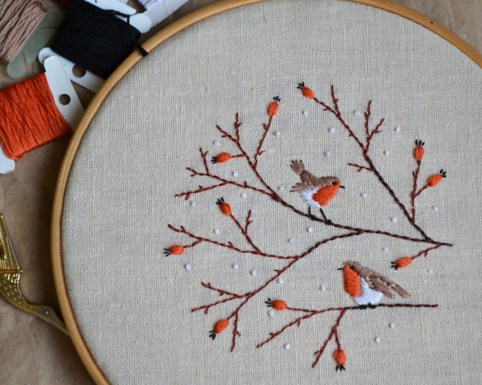 Hand embroidery with birds and berries