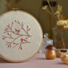 Hand embroidery with birds and berries