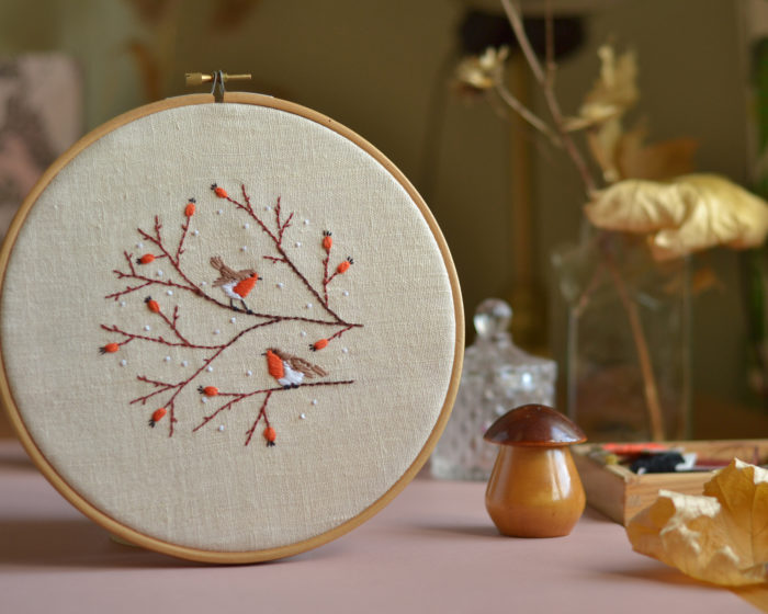 Hand embroidery with birds and berries